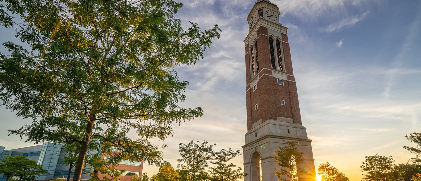 Looking up at Elliott Tower with the sun behind it.