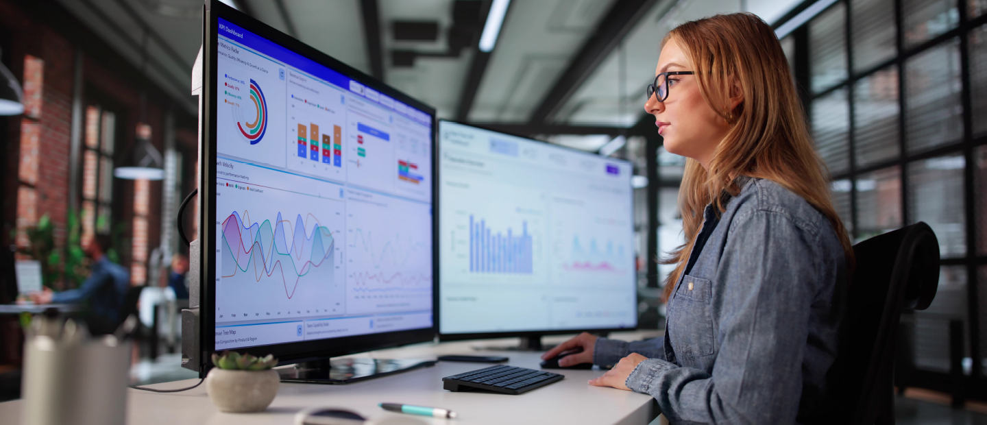 An analyst looking at data on a computer