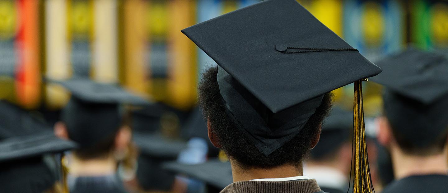 A photo looking down at graduates wearing caps and gowns