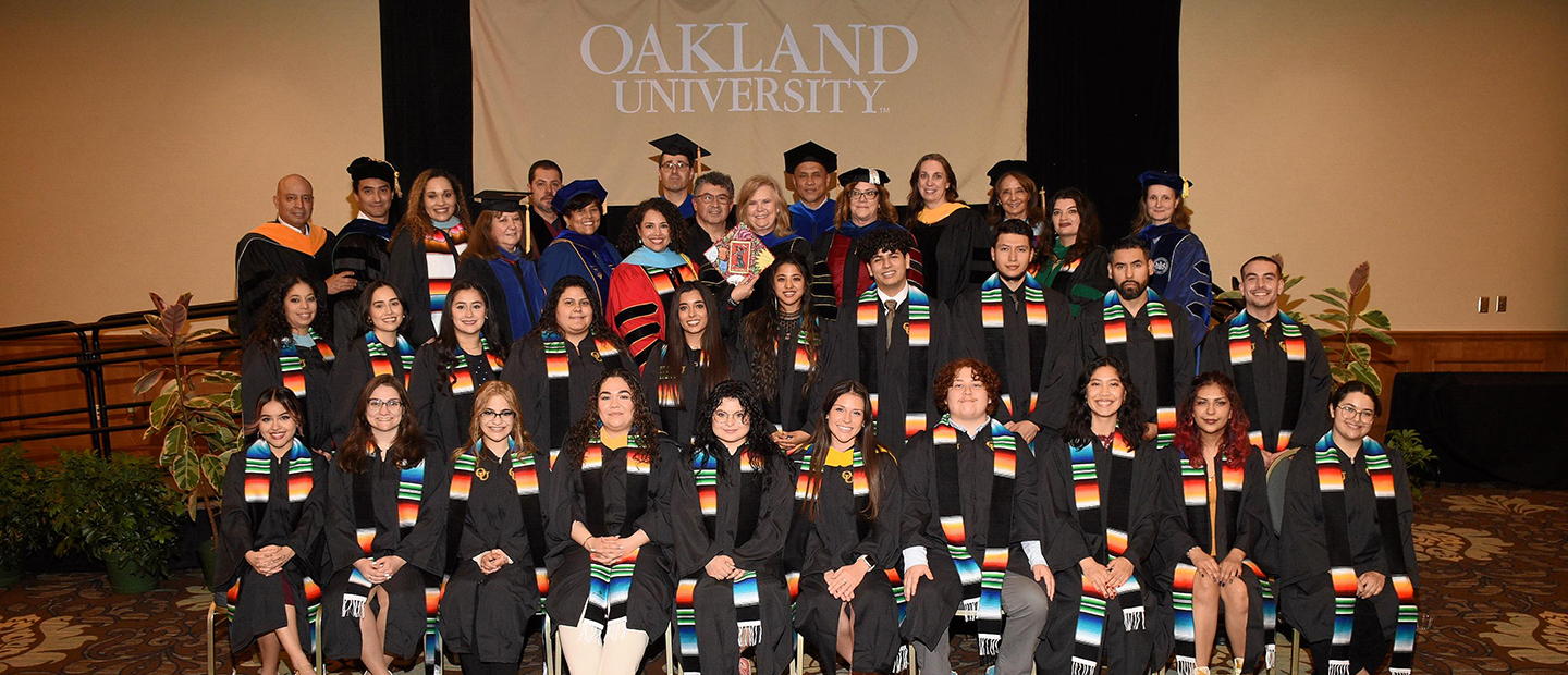 Group of students in graduation gowns at Latina/o/x graduation ceremony