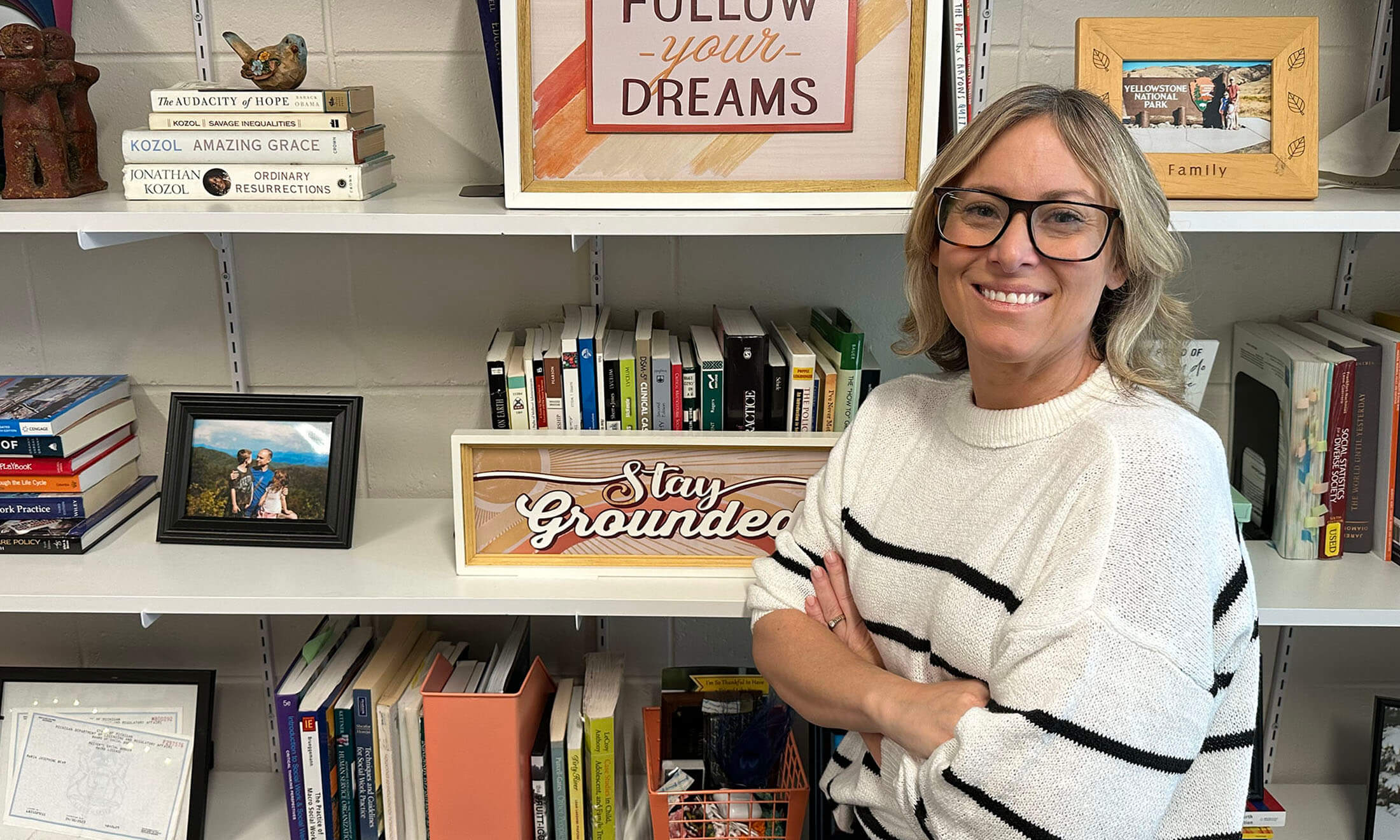 Woman standing in front of bookcase