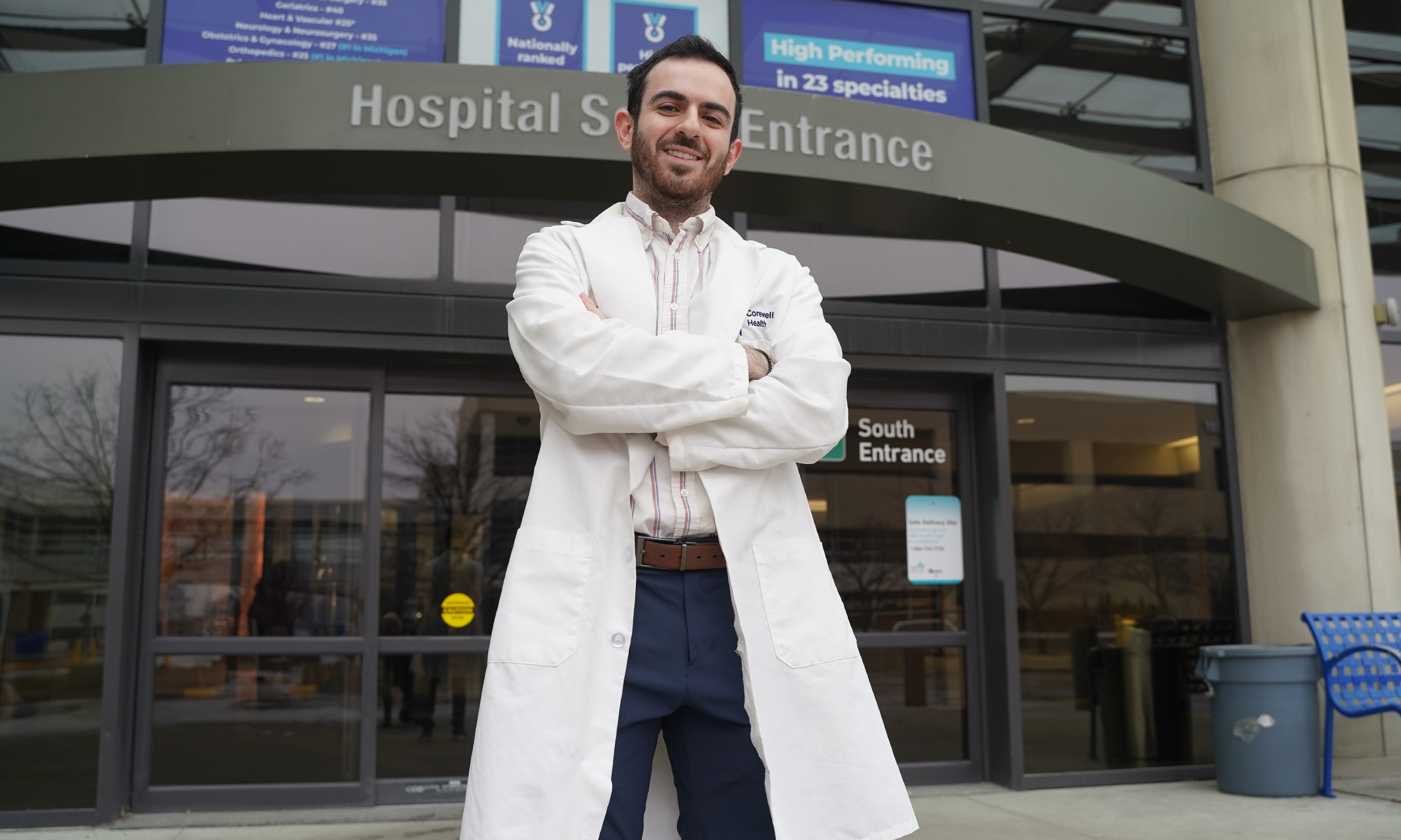 Hazem Alakhras, M.D., in front of Corewell Health's Royal Oak hospital