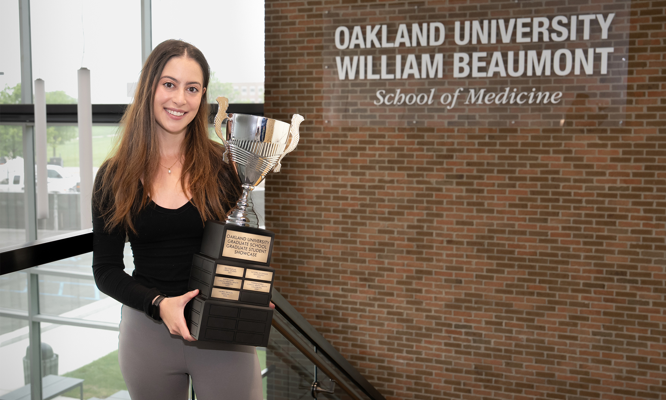 An image of a student holding a trophy
