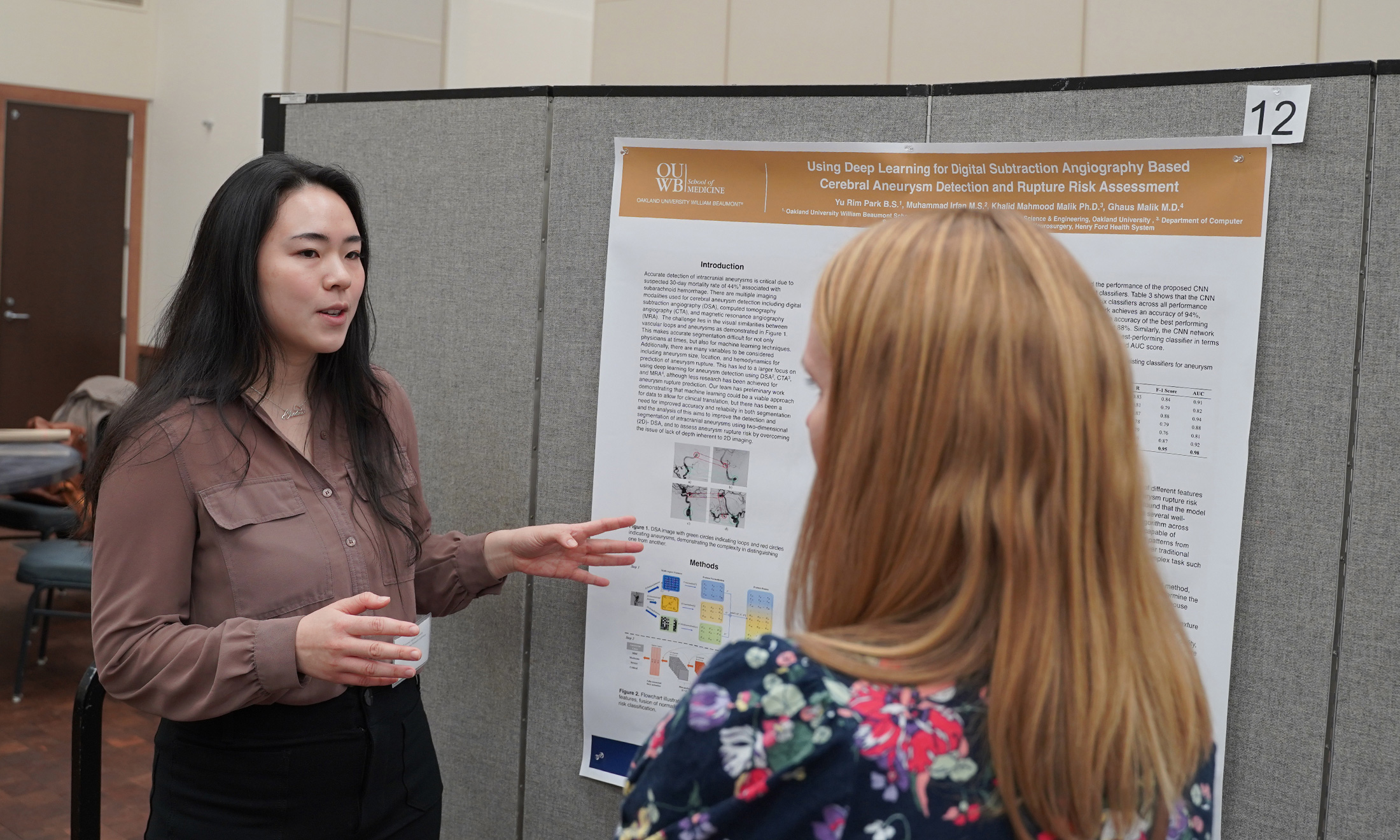 An image of a student talking about her poster