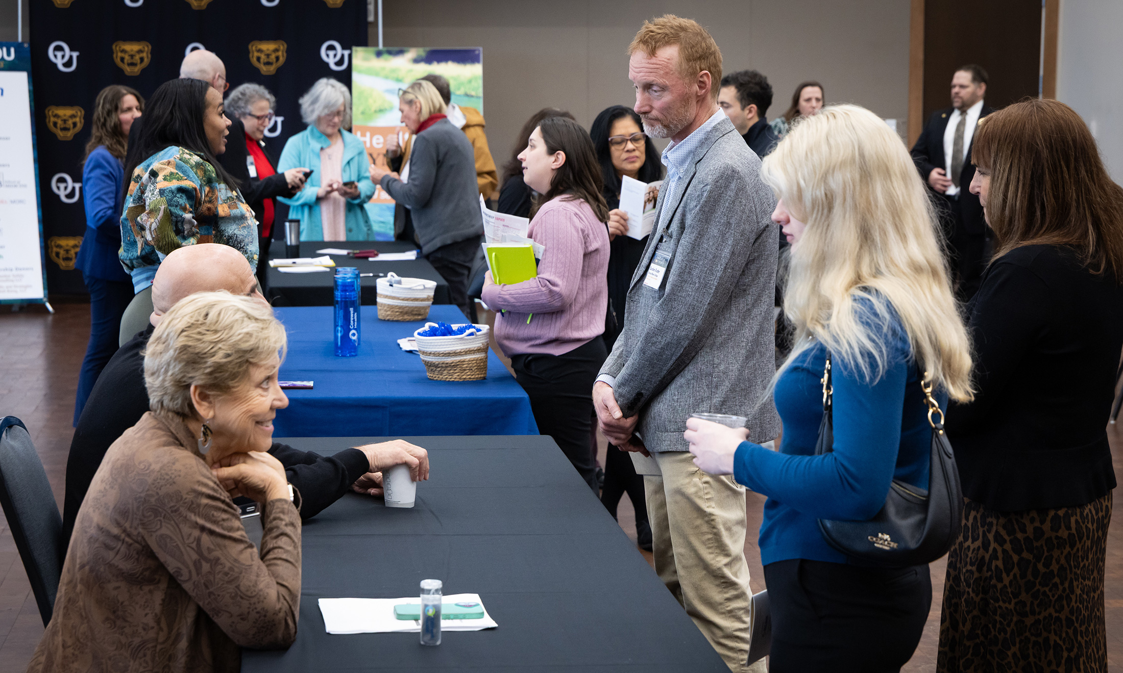 A group of people engage in discussion with a health professional and speaker