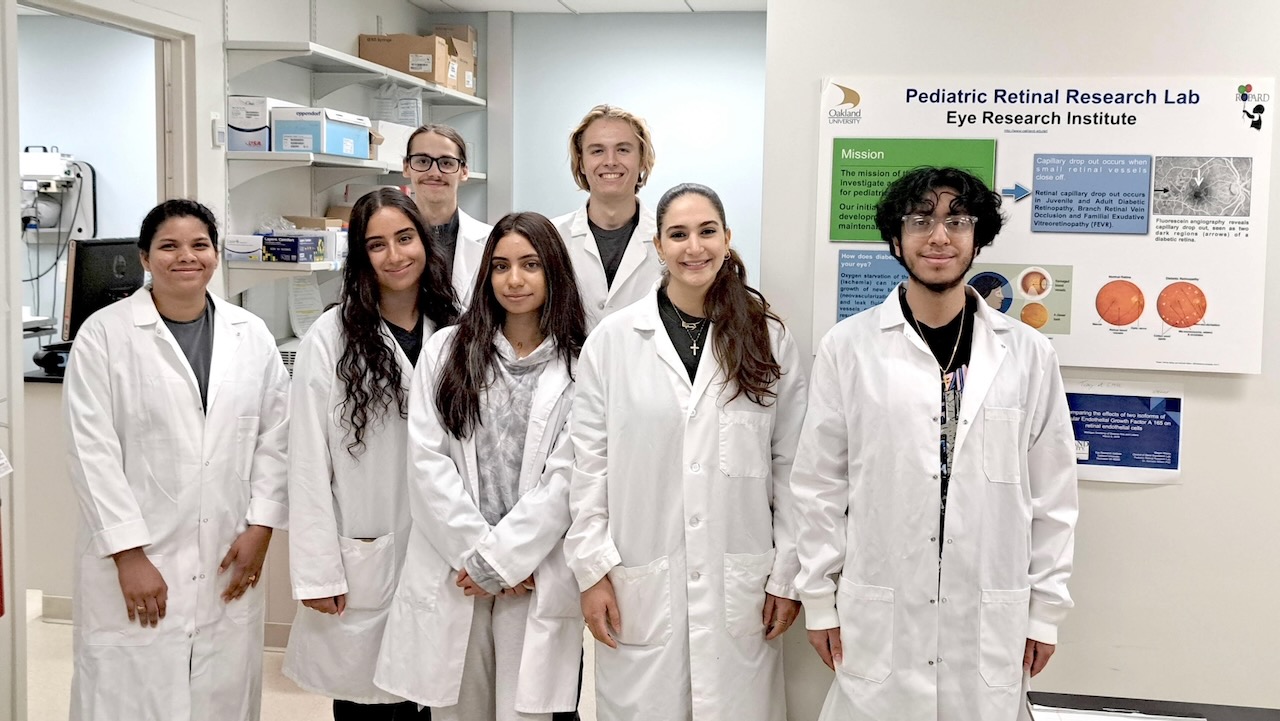 OU SUPER Symposium students in white lab coats in lab