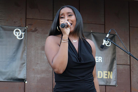A woman on stage with a microphone.