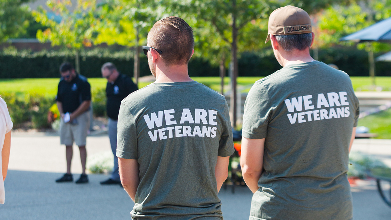Two men wearing t-shirts that say 'We Are Veterans'