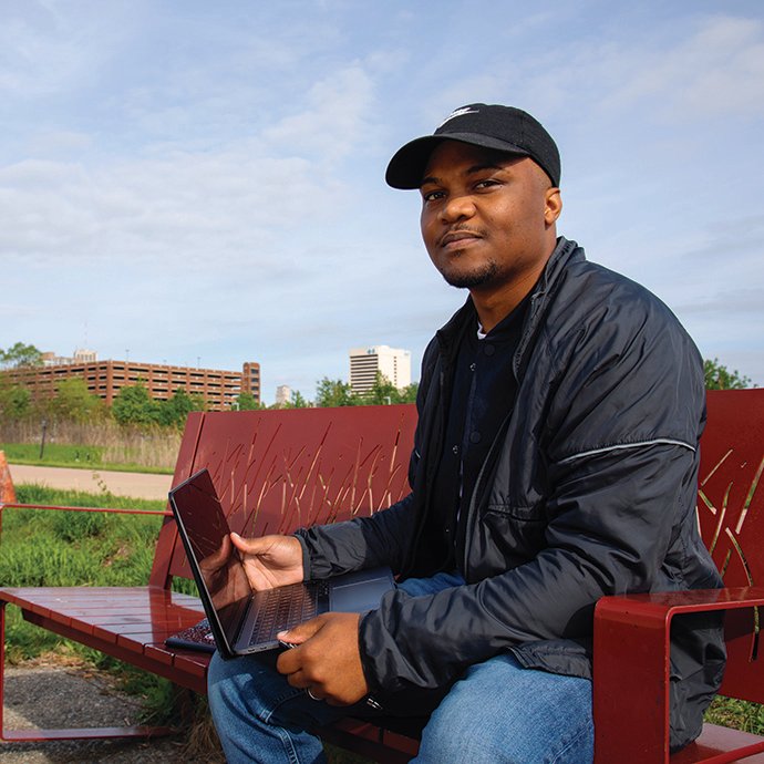 Man on a bench with a laptop