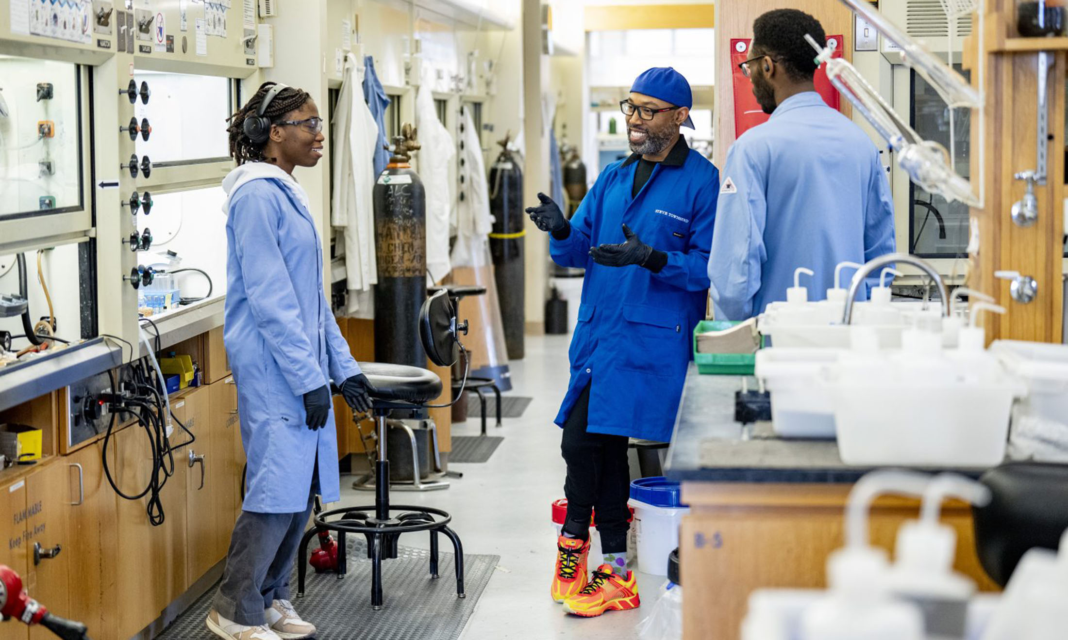 Three people standing in lab