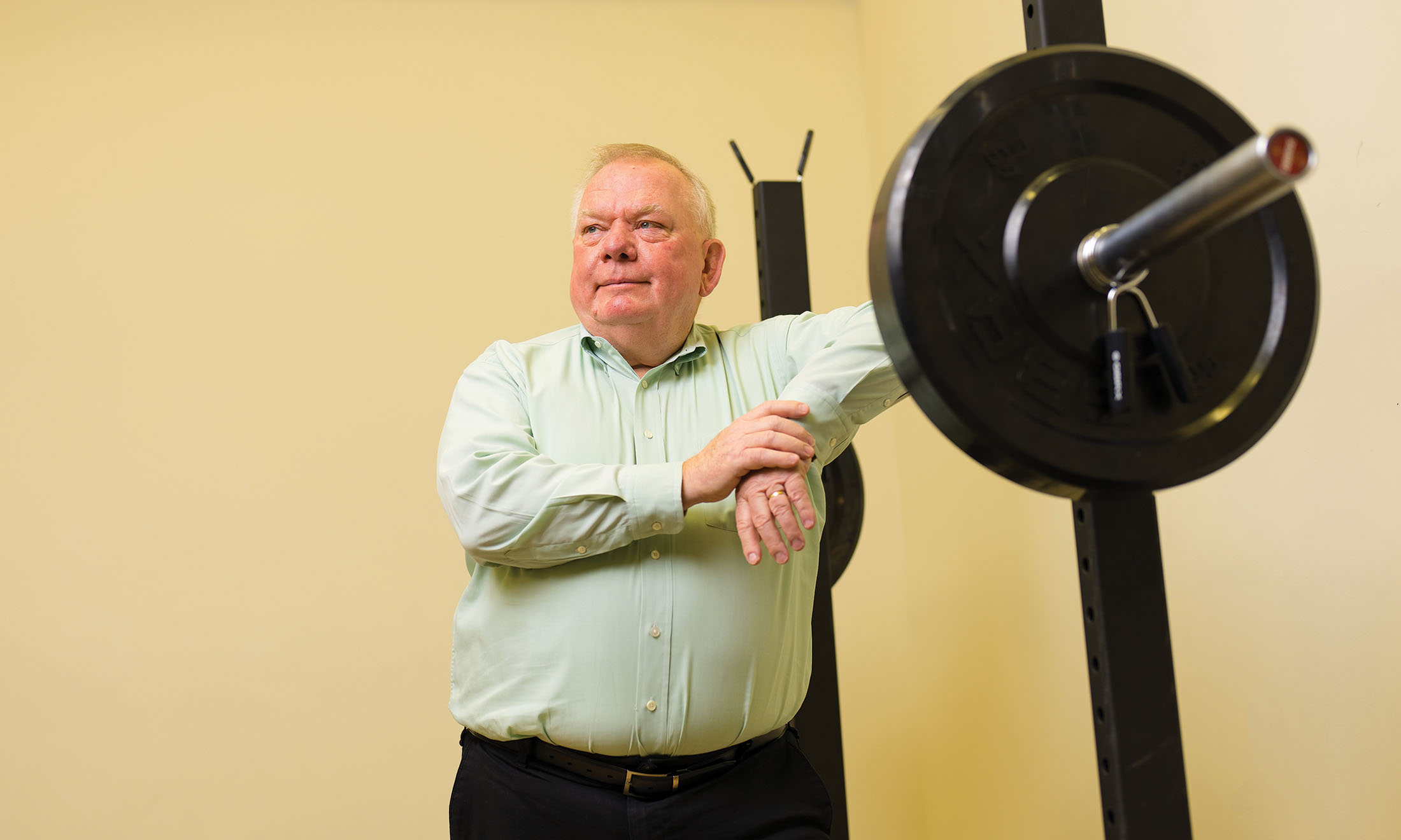 Terry Dibble leaning against weight