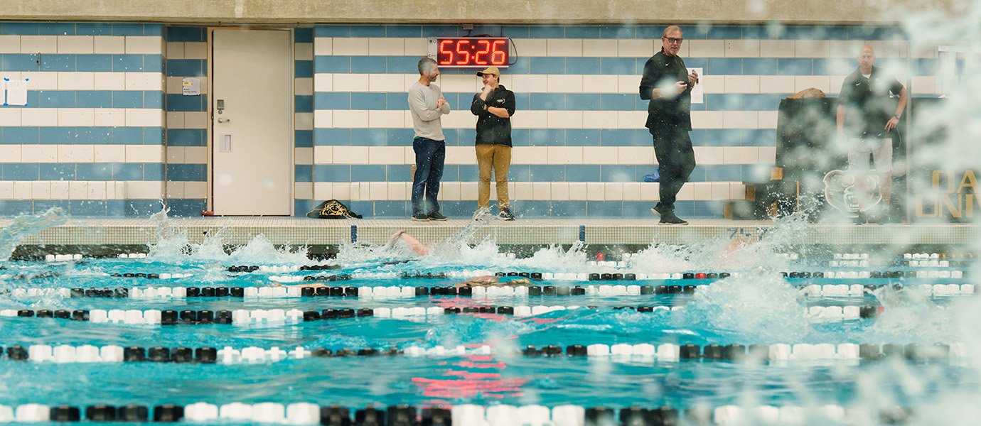 Man walking alongside pool
