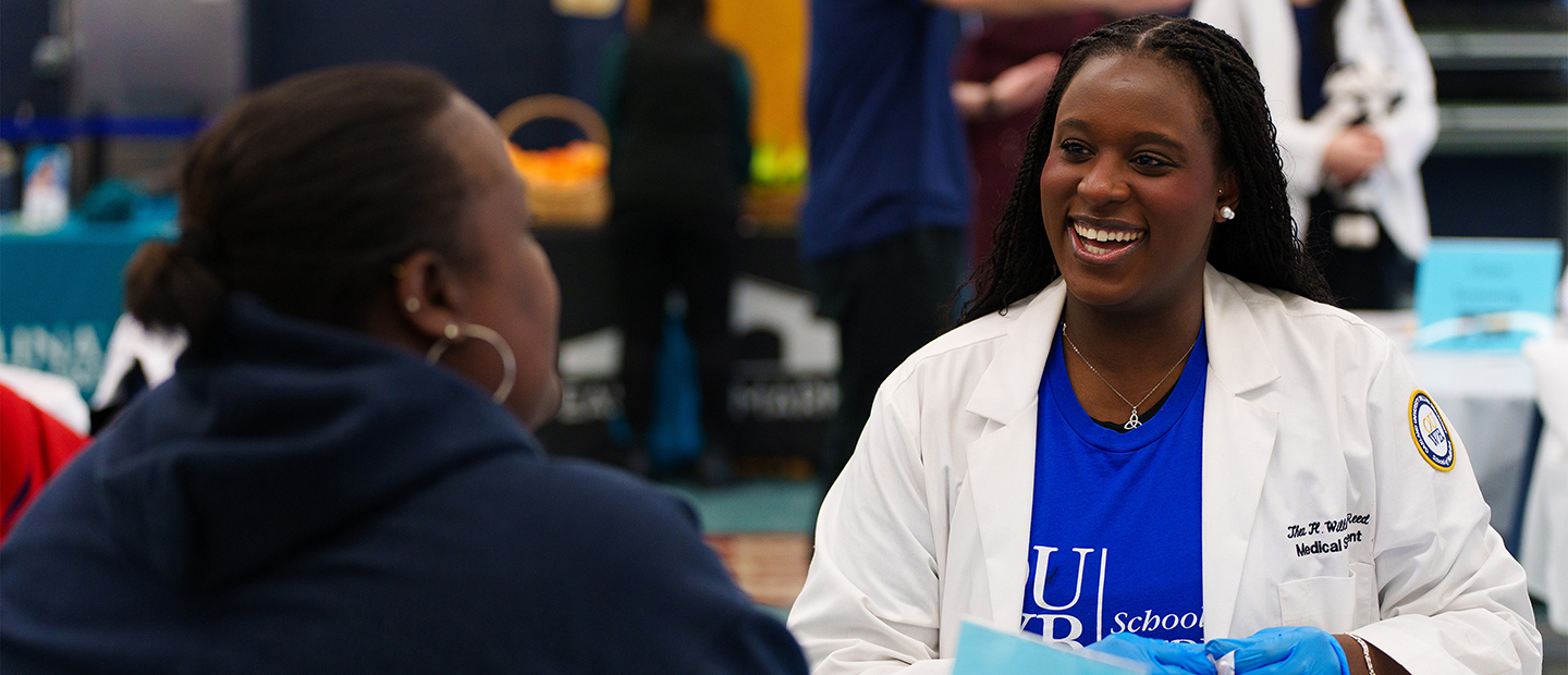 An image of an OUWB student at a community event
