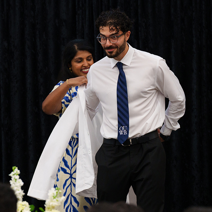 An image of a student receiving a white coat