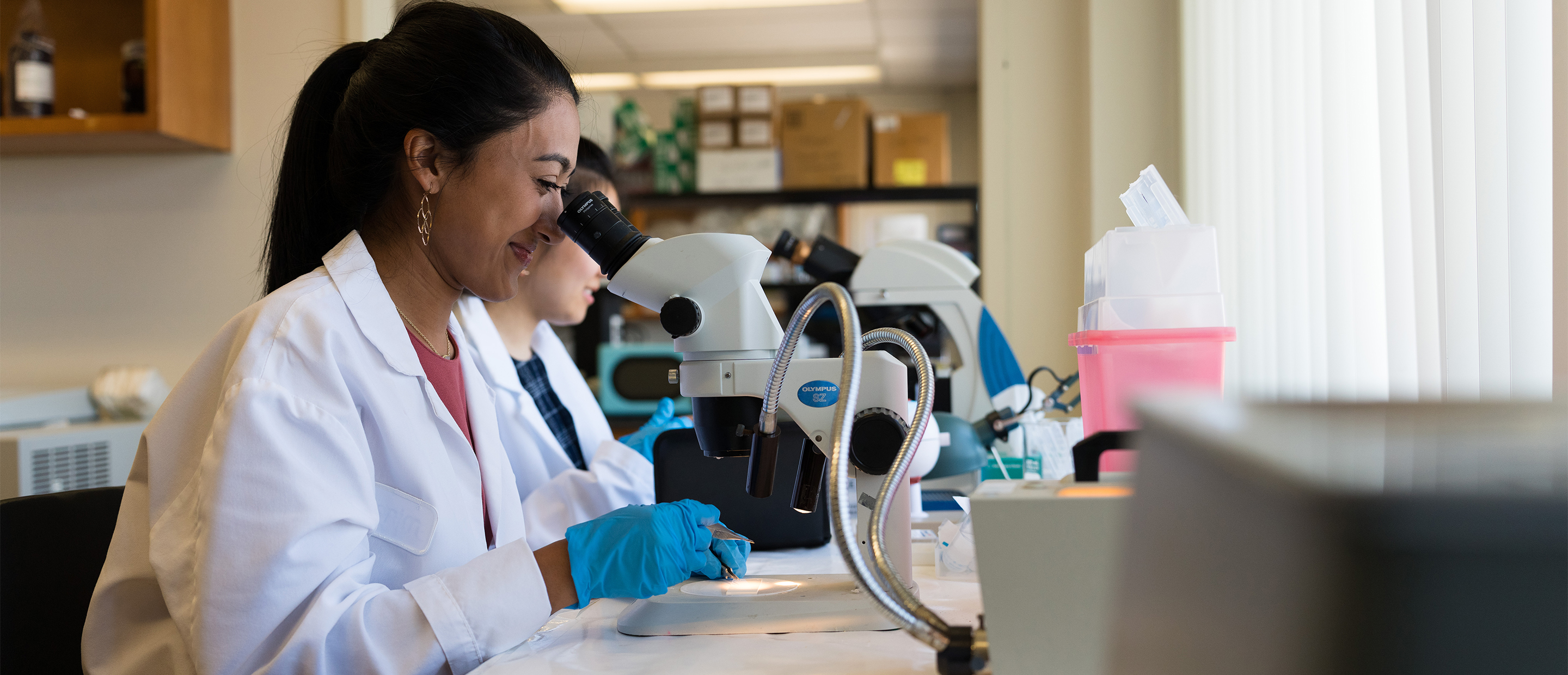 An image of a student at a microscope