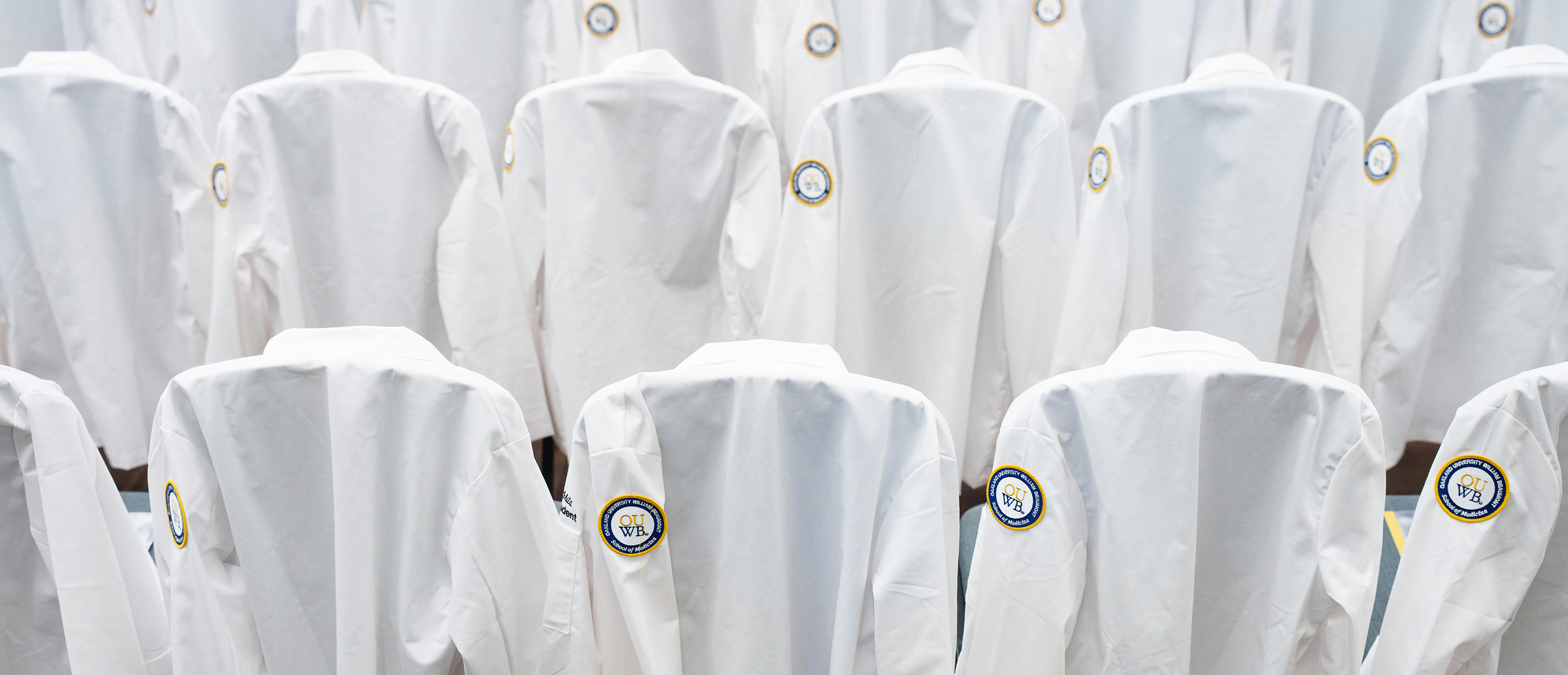 An image of white coats with the OUWB patch