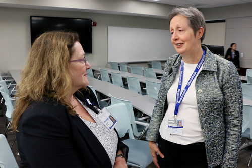 An image of two people talking to each other