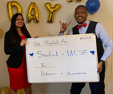 An image of two people holding a sign