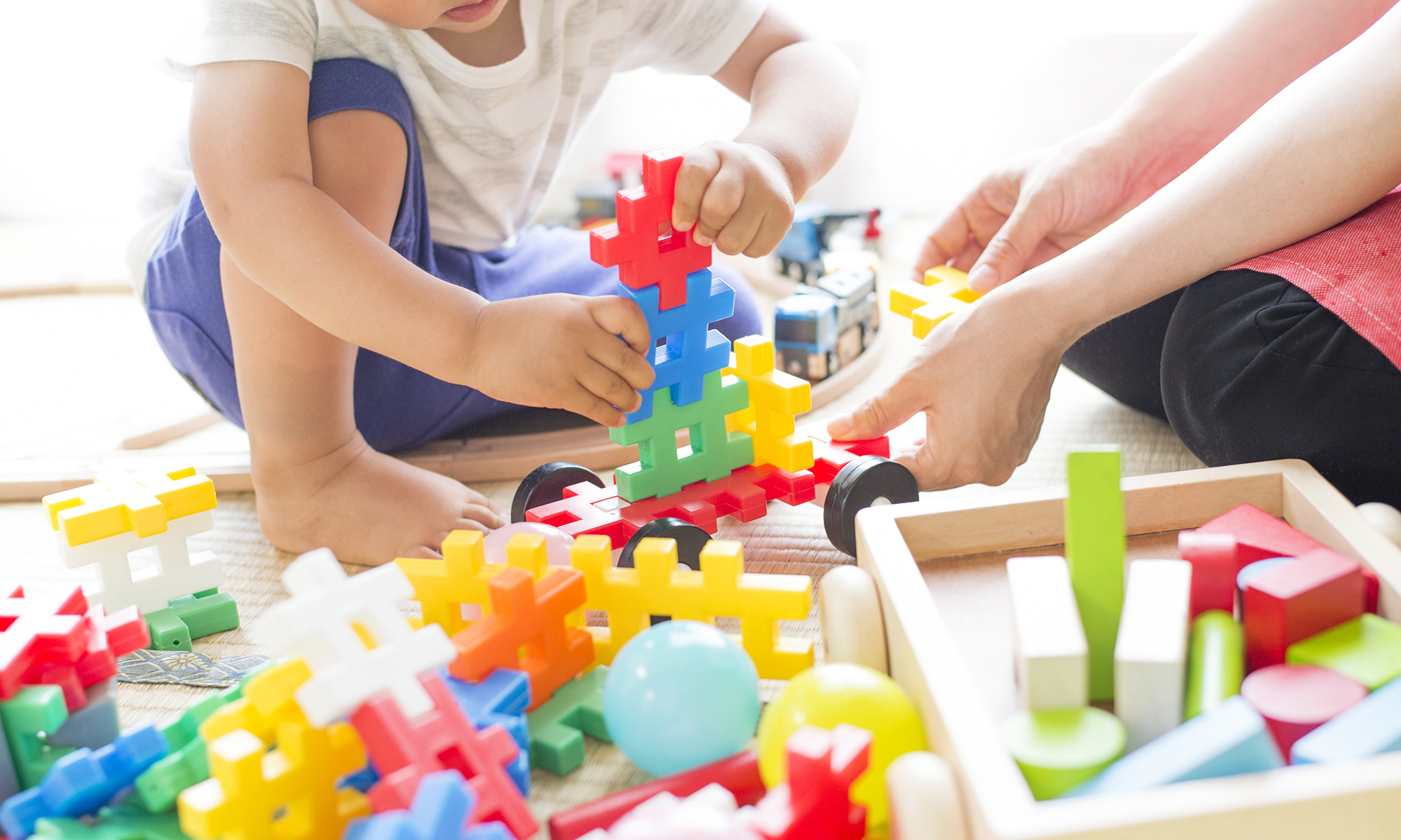 An image of people playing with toys