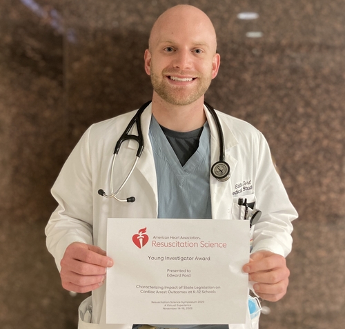 An image of Eddie Ford holding a certificate