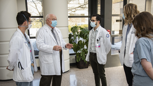An image of Dr. Mezwa talking with students