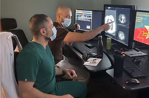 An image of two people looking at computer screens