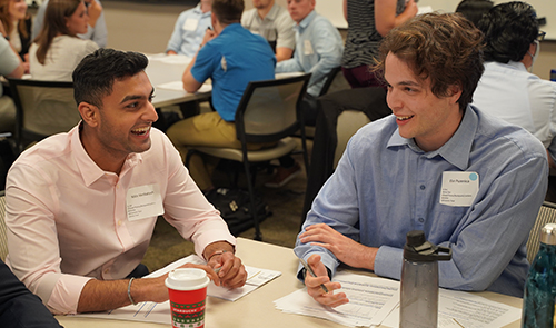 An image of two students speaking to each other