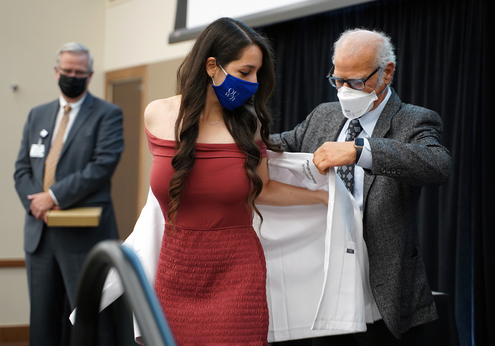 An image of a student getting her white coat