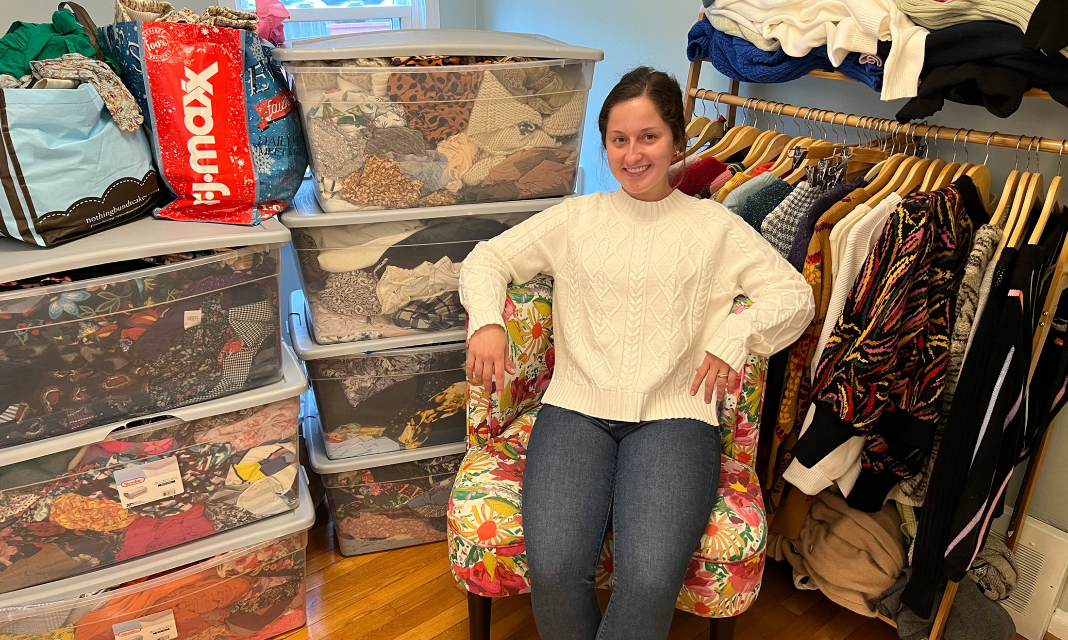 An image of a student in a closet of clothes