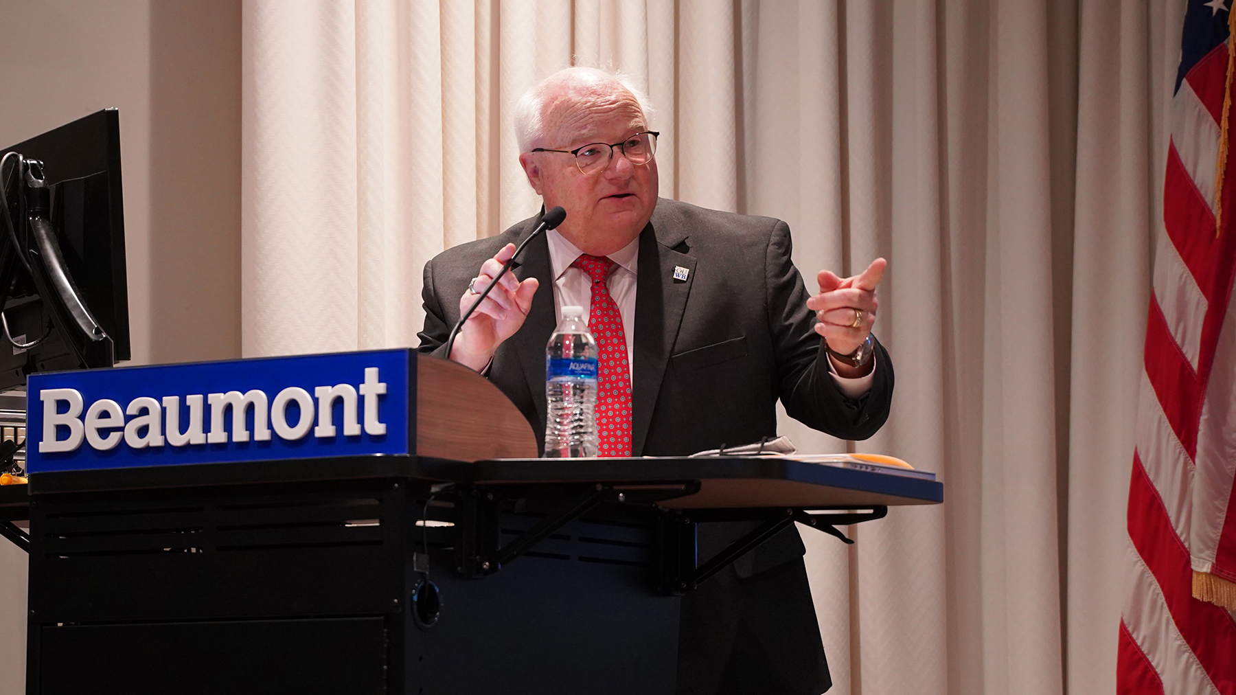 An image of Dr. Mezwa at a podium