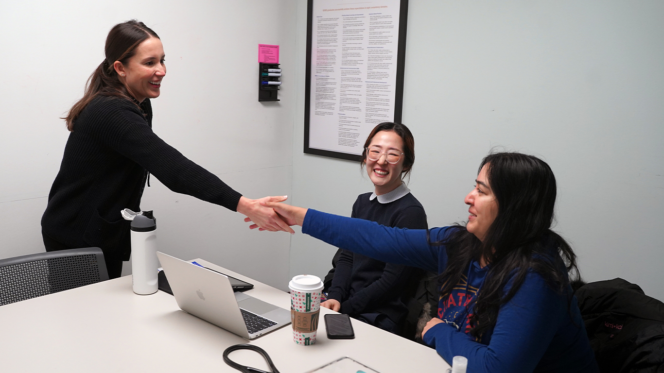An image of Mariana Allushuski greeting students