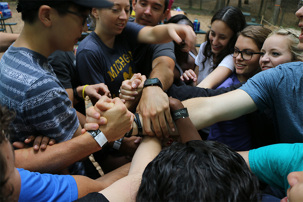 An image of OUWB students holding hands