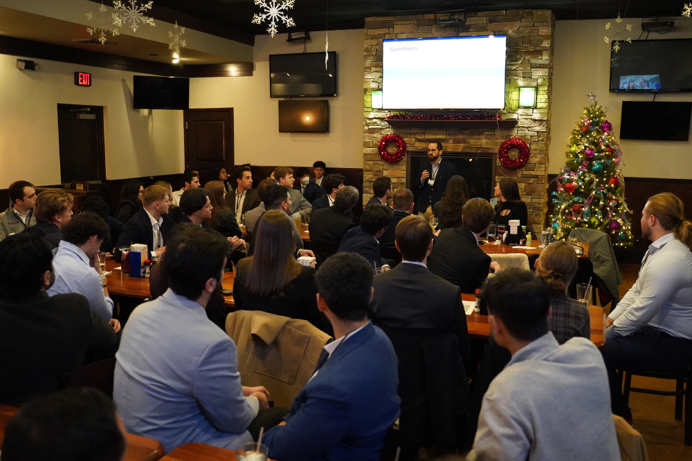 A doctor stands in front of a group of students speaking to them