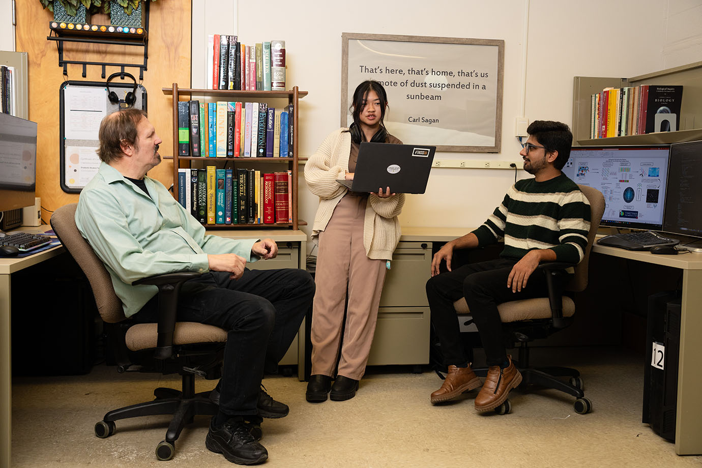 three students in the lab discussing research