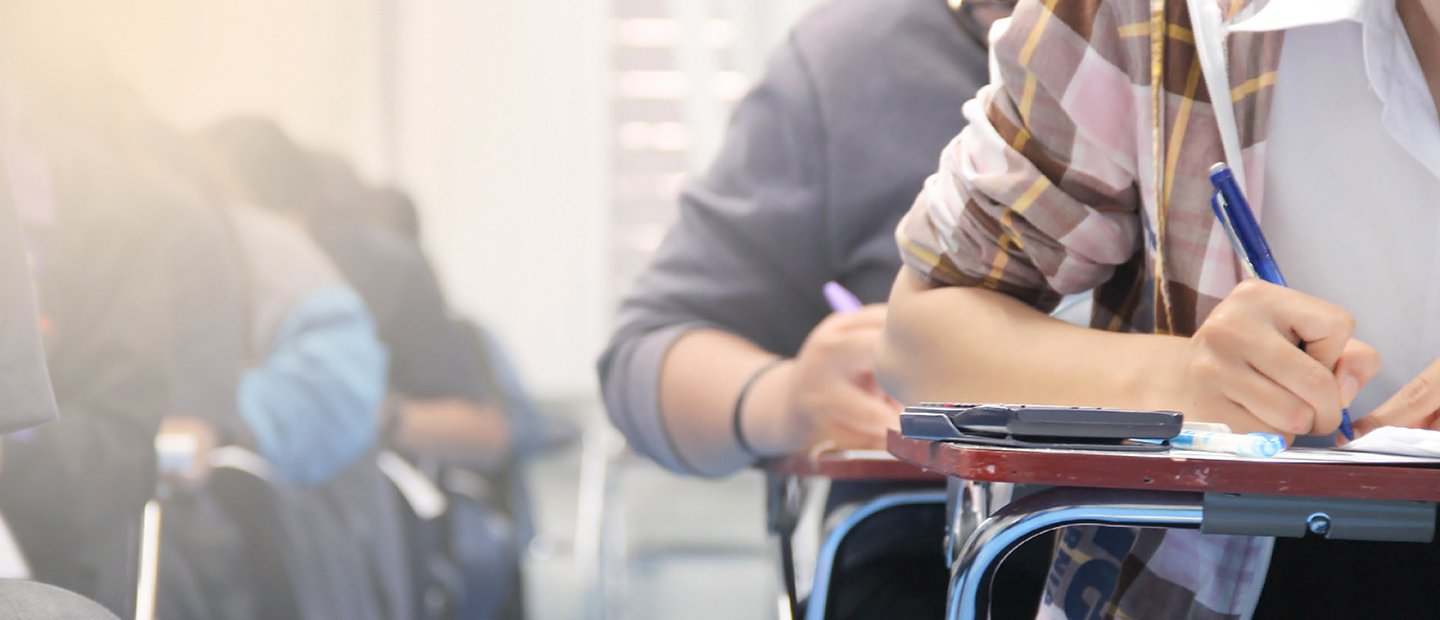 Rows of students seated at desks