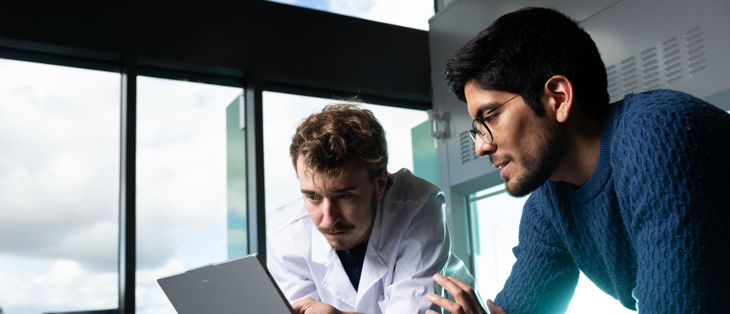 Two people working on a computer