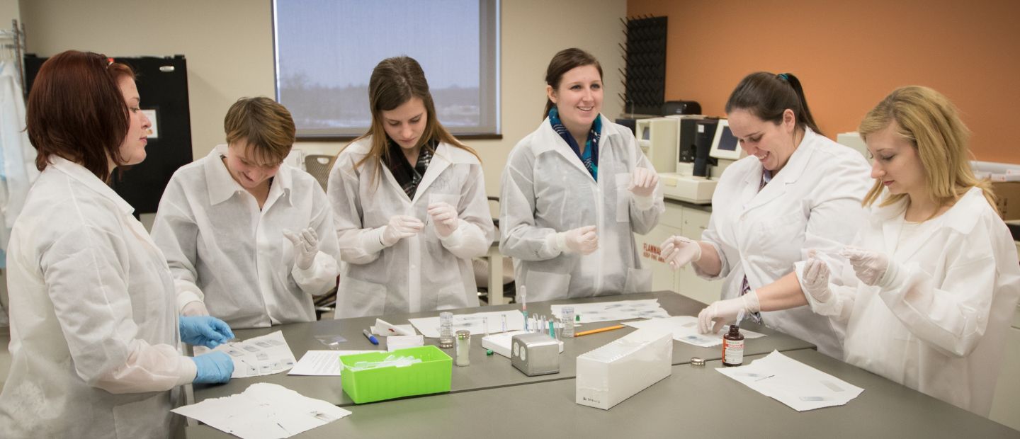 People using microscope in lab