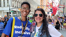 Raya Hollis smiles at the camera with a friend at an event