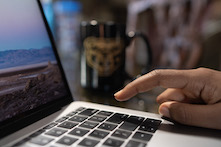 close up image of a person typing on a computer