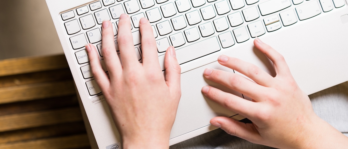 Hands typing on a keyboard