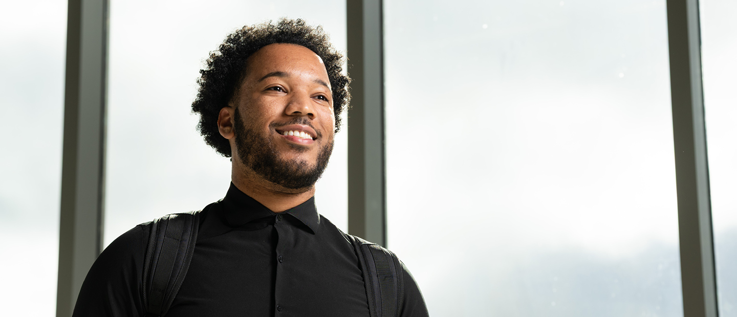 Male student with a black shirt looking off to his right.